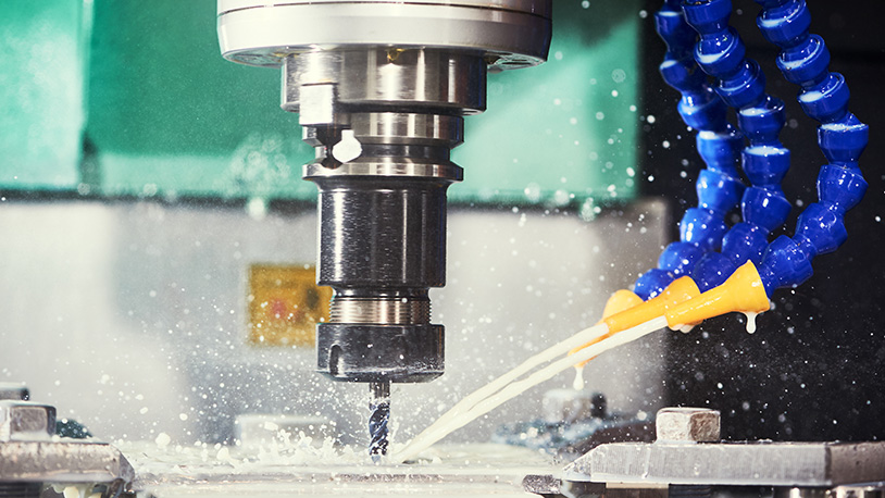 Advanced manufacturing machine spraying water and cutting material.