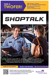 Two people discussing car maintenance in a garage setting with a vehicle hood open behind them.